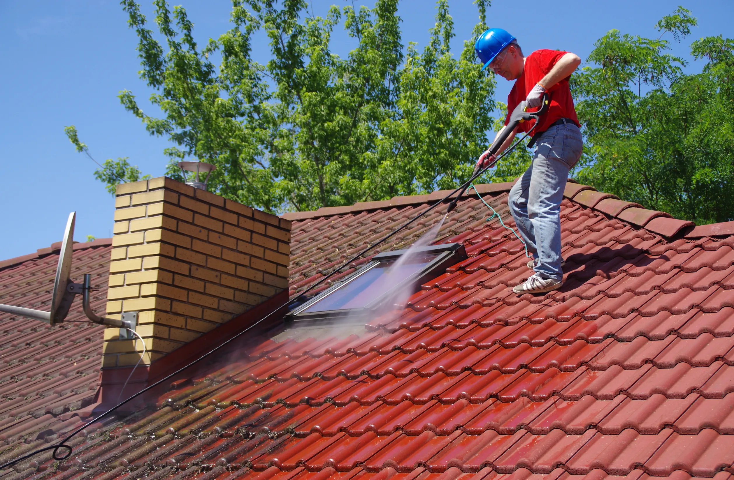 stock-photo-house-roof-cleaning-with-pressure-tool-worker-on-top-of-building-washing-tile-with-professional-1441302884